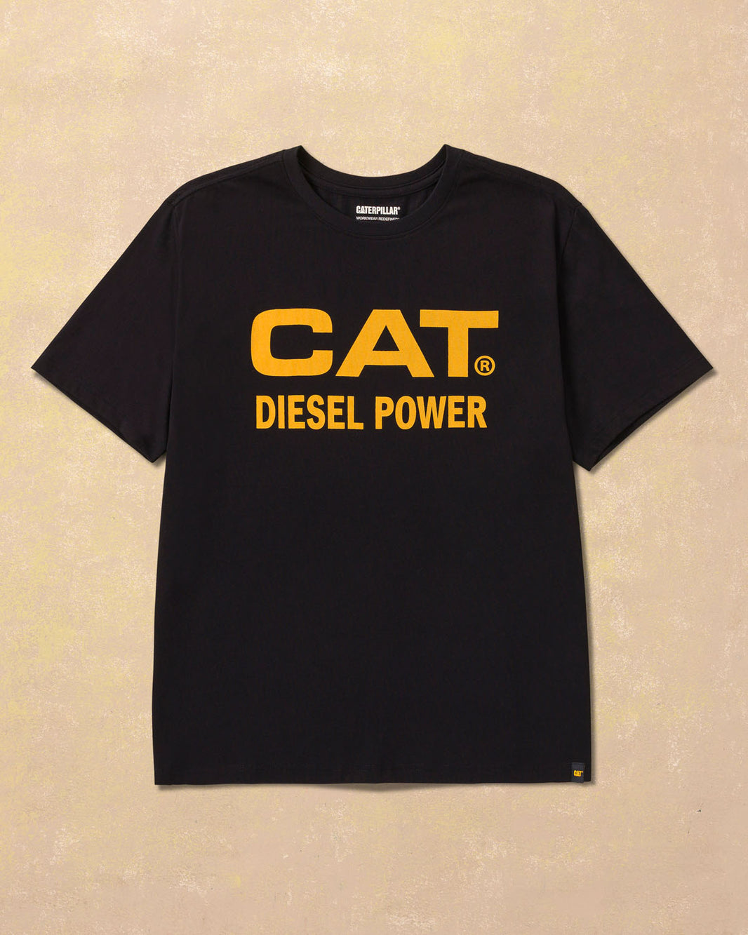 Black t-shirt with yellow 'CAT Diesel Power' text on a beige background
